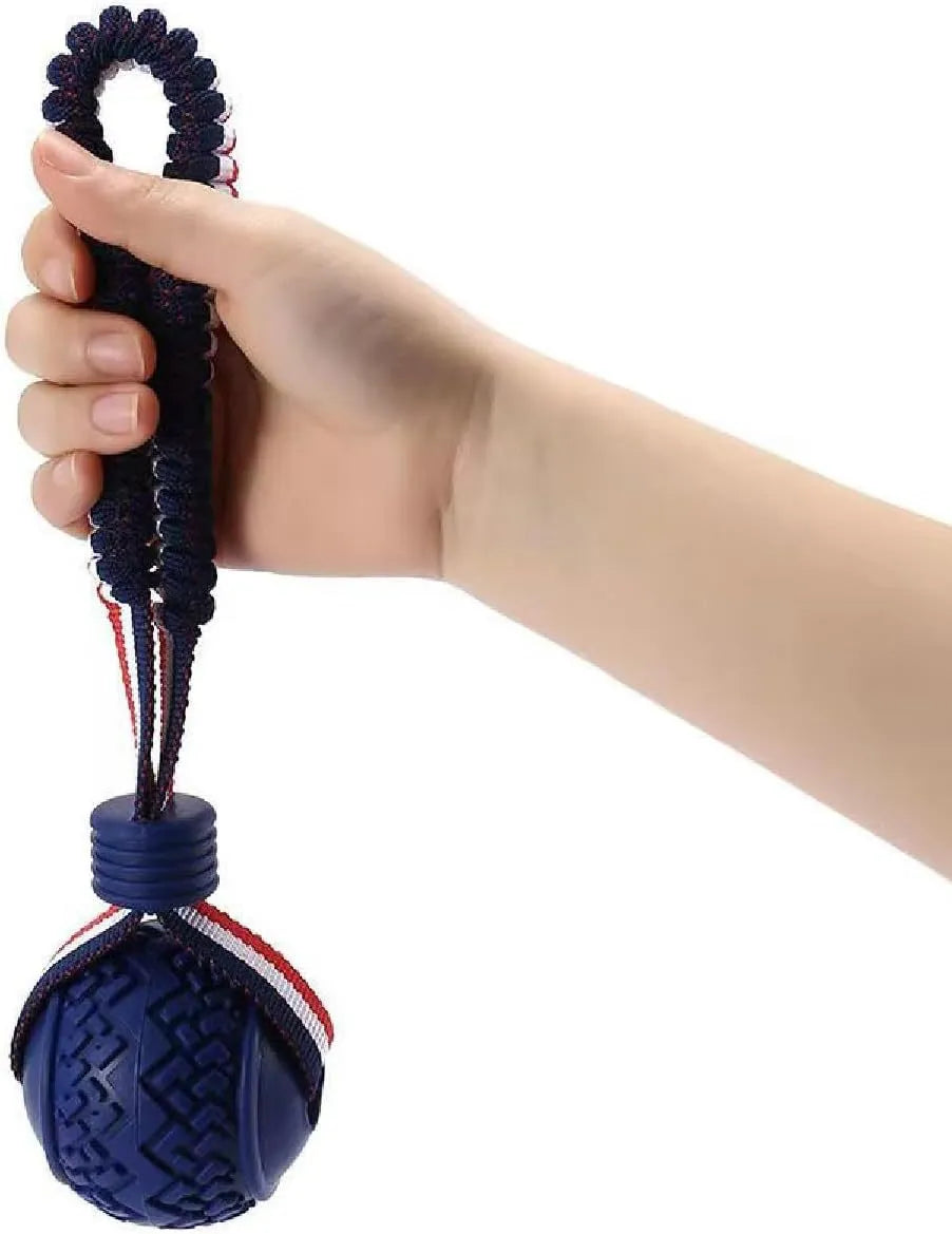 Blue or red natural rubber dog ball with rope attachment, showing textured surface and 29cm total length