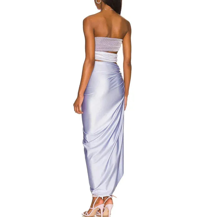 Purple women's one-piece swimsuit with hollow design and matching wrap skirt.