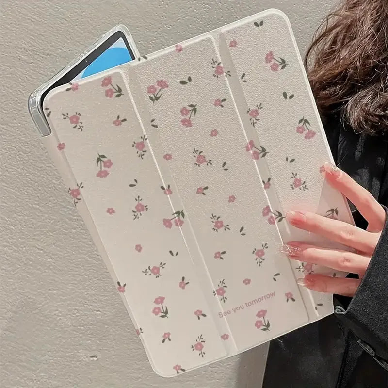 Transparent tri-fold iPad case with floral cartoon pattern, shown in standing position with magnetic closure