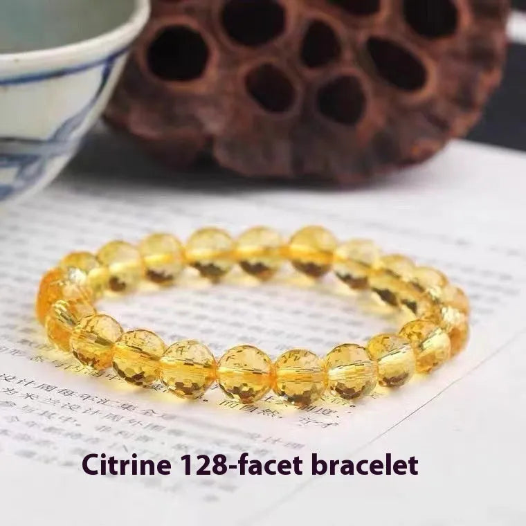 Handcrafted 128-facet crystal ametrine bracelet with detailed beads on a wrist.