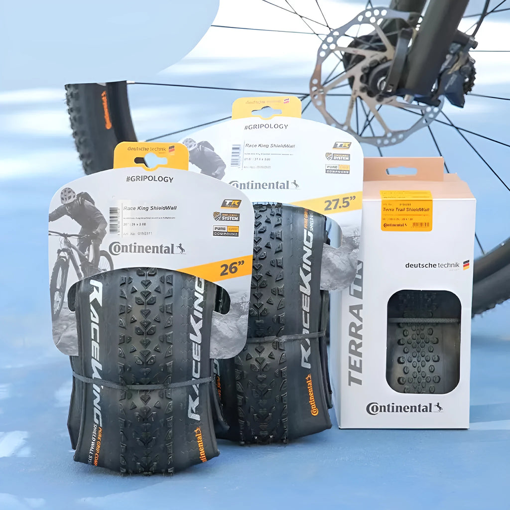 Mountain bike tyre showing tread pattern, available in yellow and white colours for 26, 27.5, and 29-inch wheel sizes
