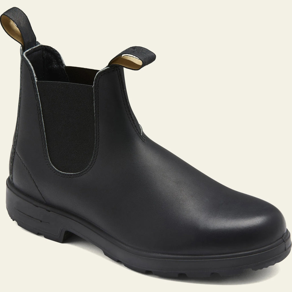 Vintage brown unisex Chelsea boot with frosted PU upper and round toe on a wooden surface.