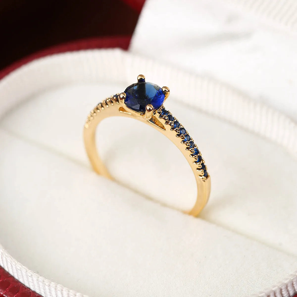 Geometric hexagon copper ring with colourful zircon stones in a metallic electroplated finish.