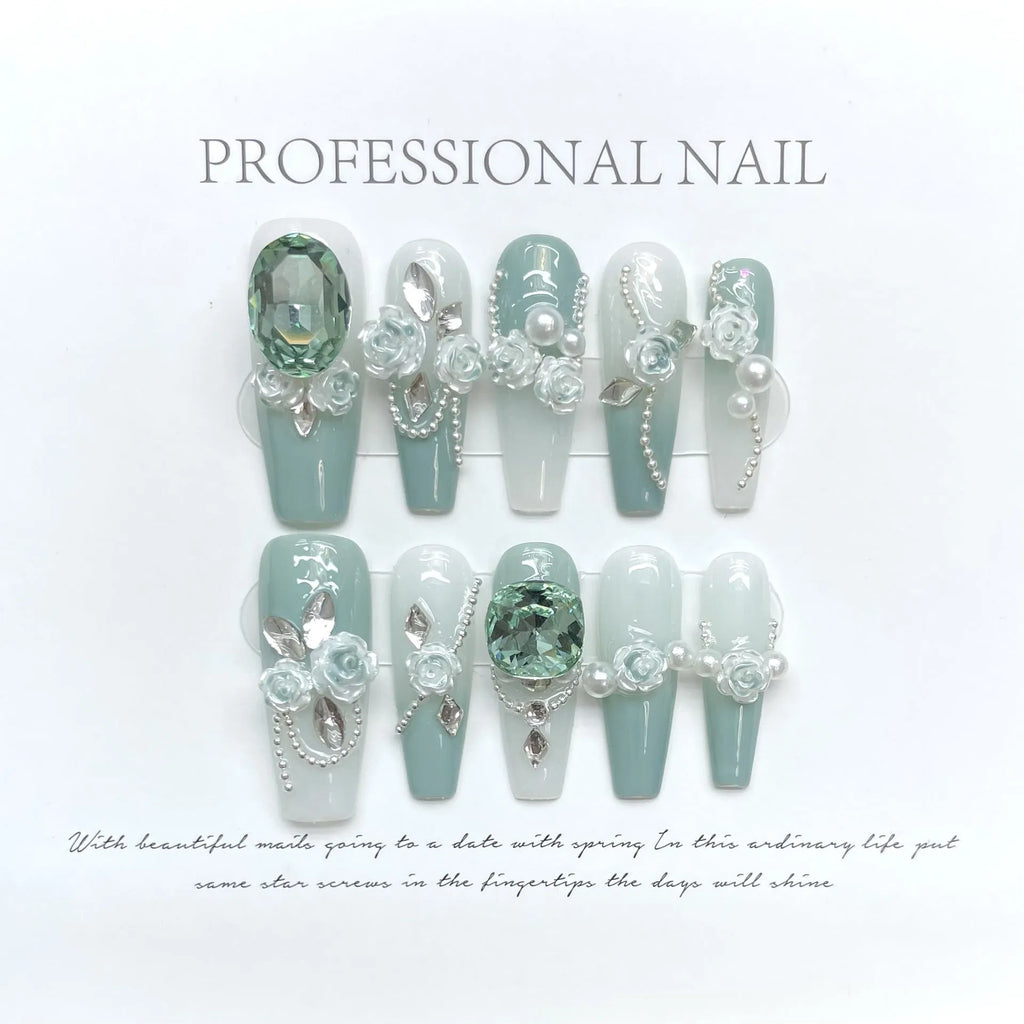Green plastic nail armour suit with diamond accents and a gradient camellia chain decoration.