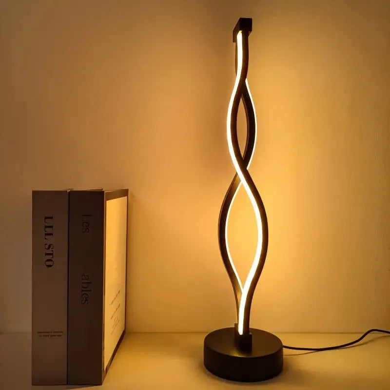 Black aluminium desk lamp with touch dimming controls and USB power cable