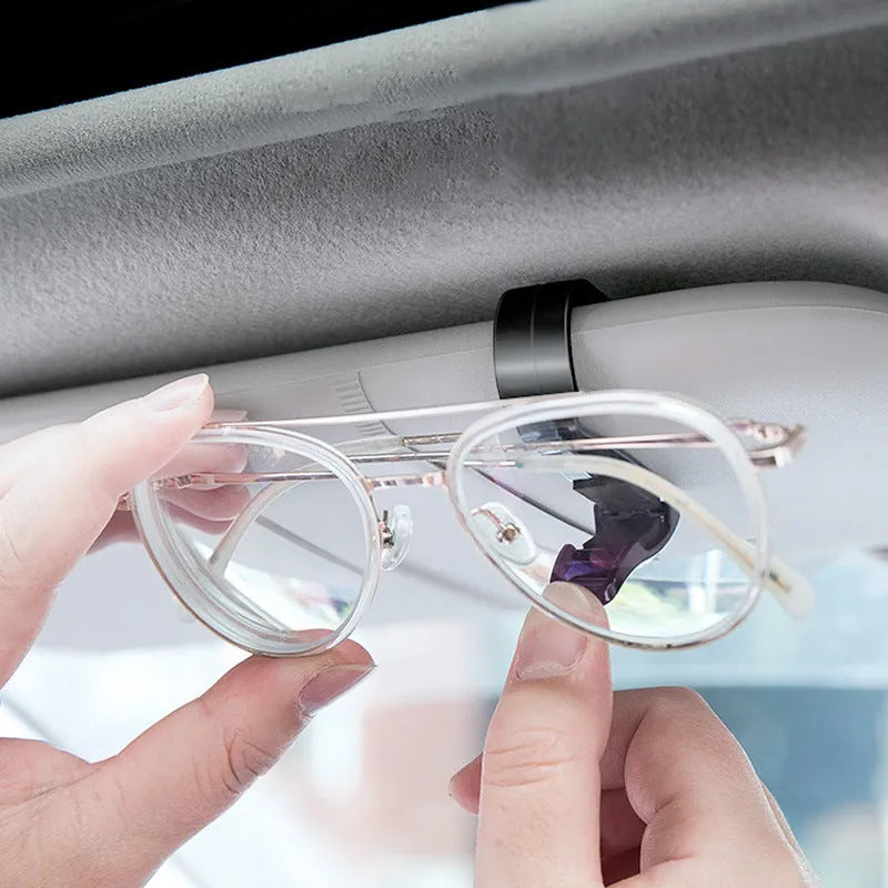 Black plastic clip holder for car sunshade to hold glasses, ID cards, and tickets.