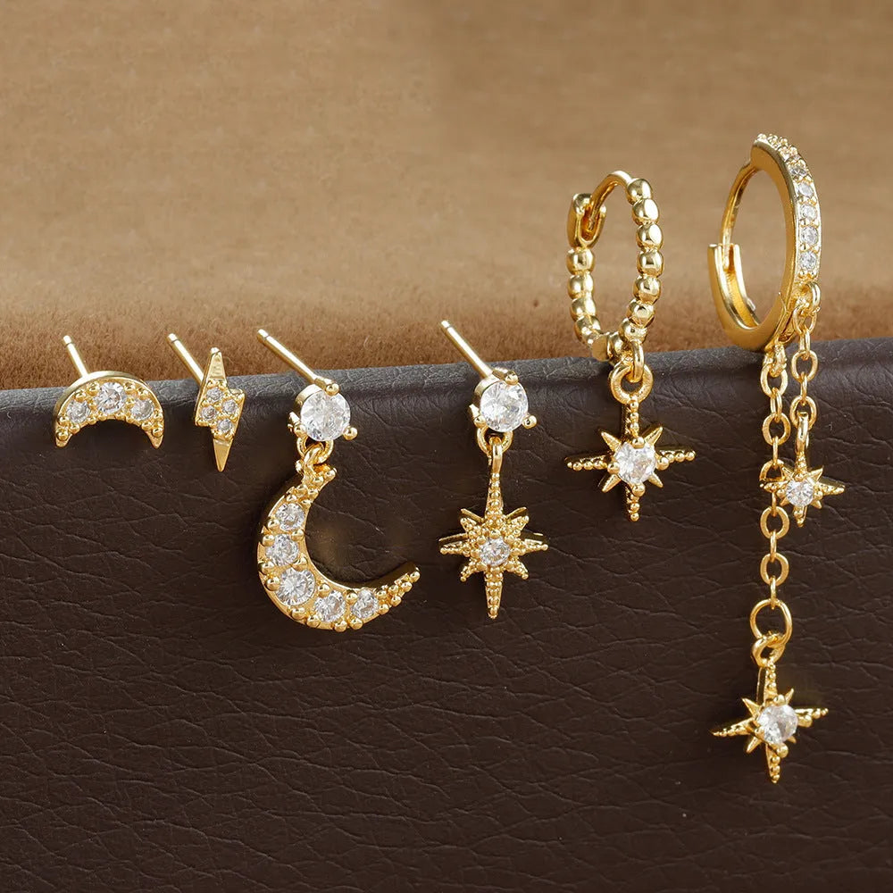 Six pairs of gold electroplated earrings with chain tassel and zircon stud designs representing different months