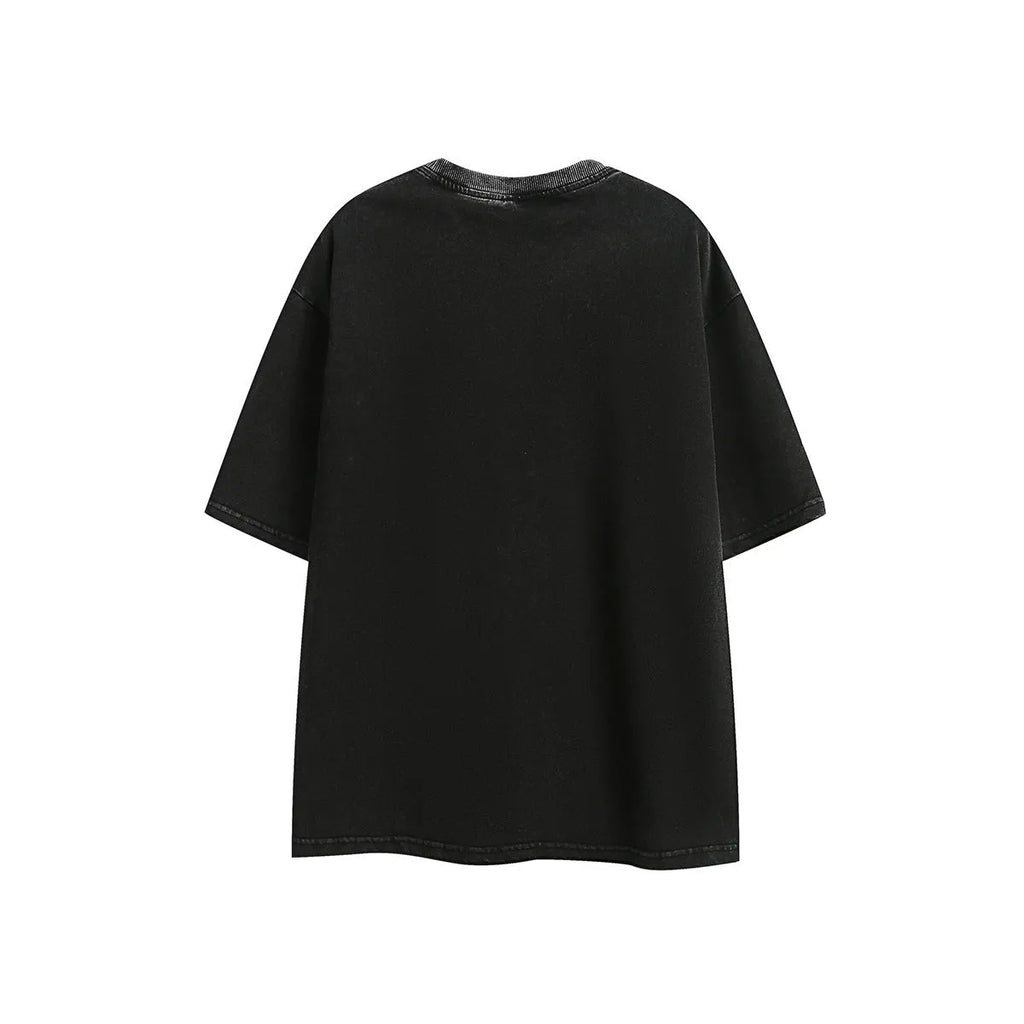 Man wearing a loose black retro short-sleeved cotton T-shirt with an embroidered washed design