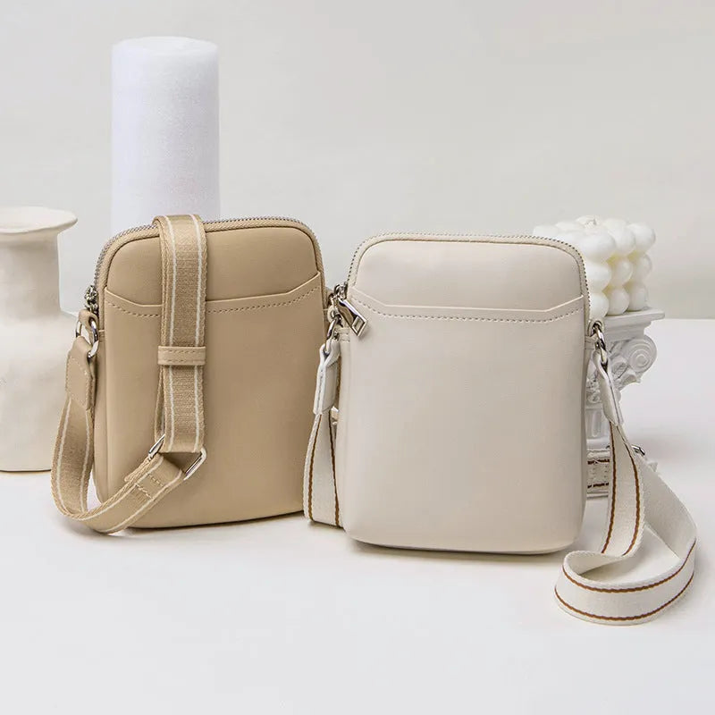 Solid colour small crossbody shoulder bag in PU leather measuring 14.5cm by 5.5cm by 19cm