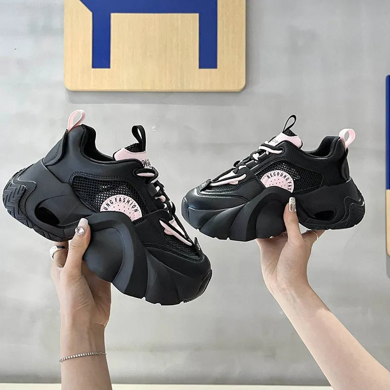 Women's pink sneakers with thick sole, cross ankle straps and mesh lining.