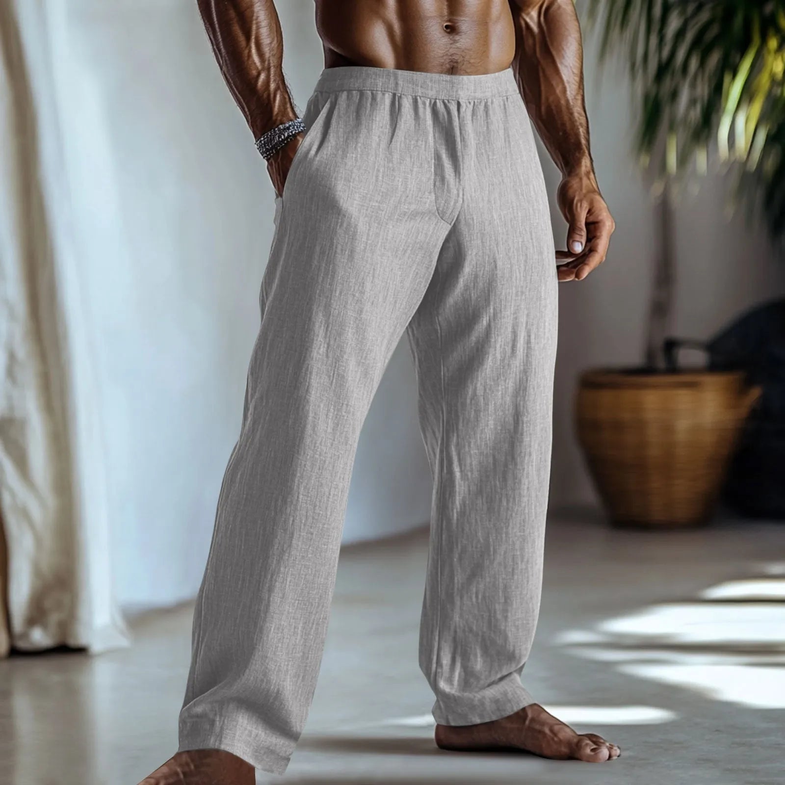 Straight leg cotton linen trousers in light green colour with visible front pockets on a plain background