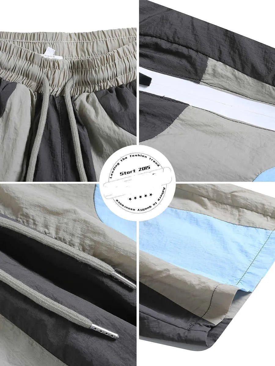 Blue men's loose patchwork quick-drying sports shorts with straight legs and elasticated waist.