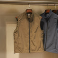 Men's thin nylon vest in straight cut with side pockets, shown in Army Green colour.