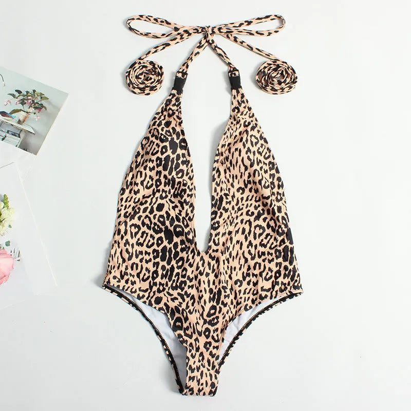 Women's leopard print one-piece bandage swimsuit with buckle detail, shown in a backless design.