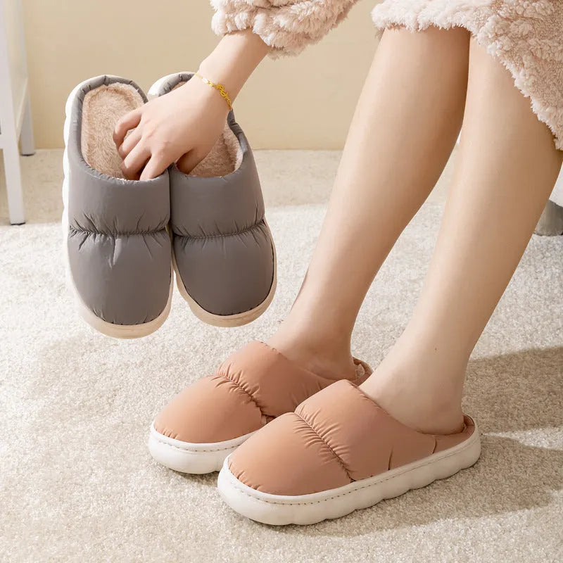 Pair of thick-soled winter slippers with artificial leather upper and plush lining, shown in a choice of colours.