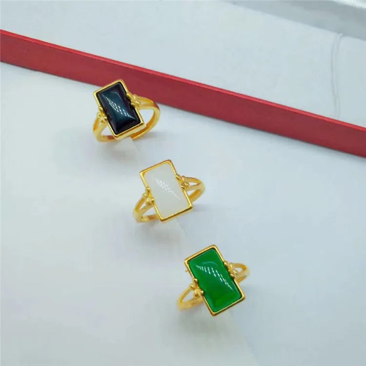 Adjustable brass gold-plated ring with gemstone in green, white or black options showing adjustable port mechanism