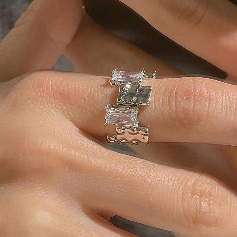 Silver geometric cross ring with open zircon gemstone design and three-dimensional decoration