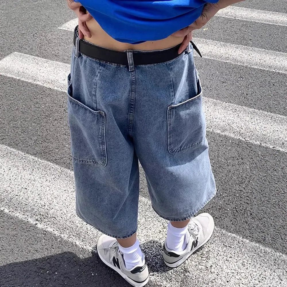 Men's washed blue denim pirate shorts with high waist and cropped length on a plain background.