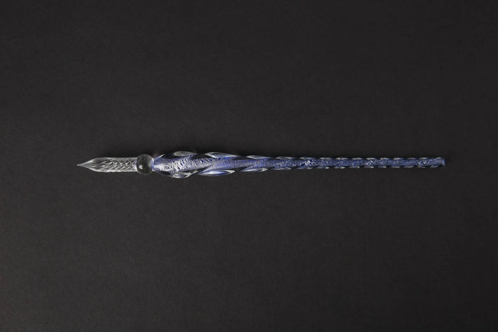 Transparent glass art pen with coloured ink dipped design in a gift box.