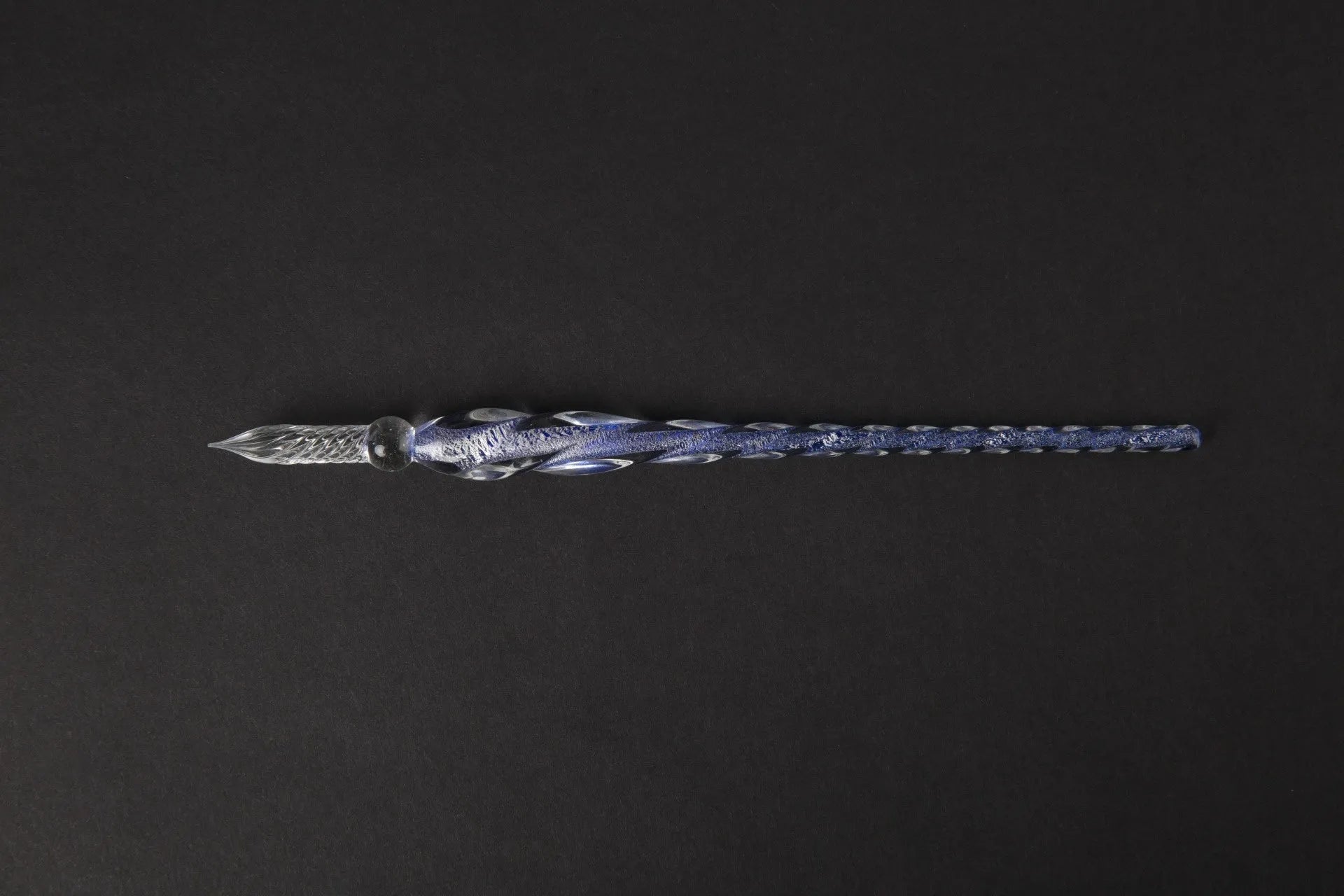 Transparent glass art pen with coloured ink dipped design in a gift box.