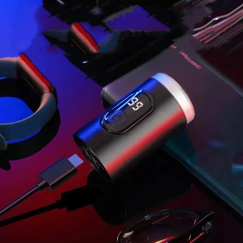 Black portable rechargeable shaver with USB charging cable and cleaning brush on a white background.