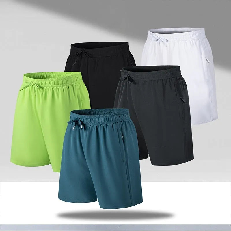 Man wearing loose fit black quick-dry sports shorts on a beach.