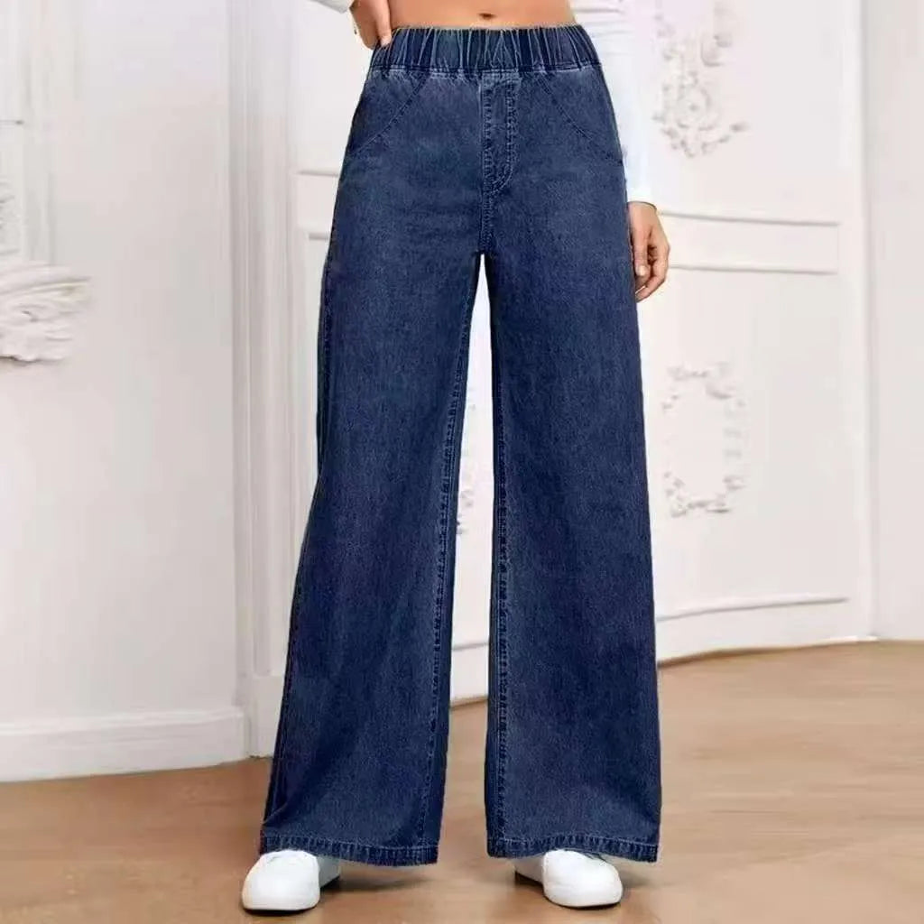 Light blue washed wide-leg denim trousers for plus size figures with mid waist and straight leg silhouette