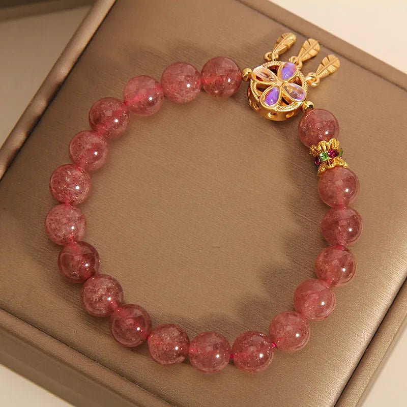 Women's strawberry quartz bracelet with four leaf dream catcher ball pendant