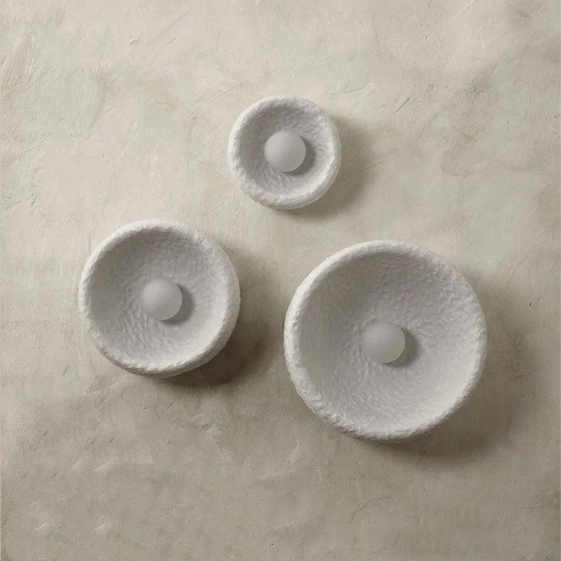 Japanese-style simple silent wall lamp with resin shade in three diameter sizes on white wall