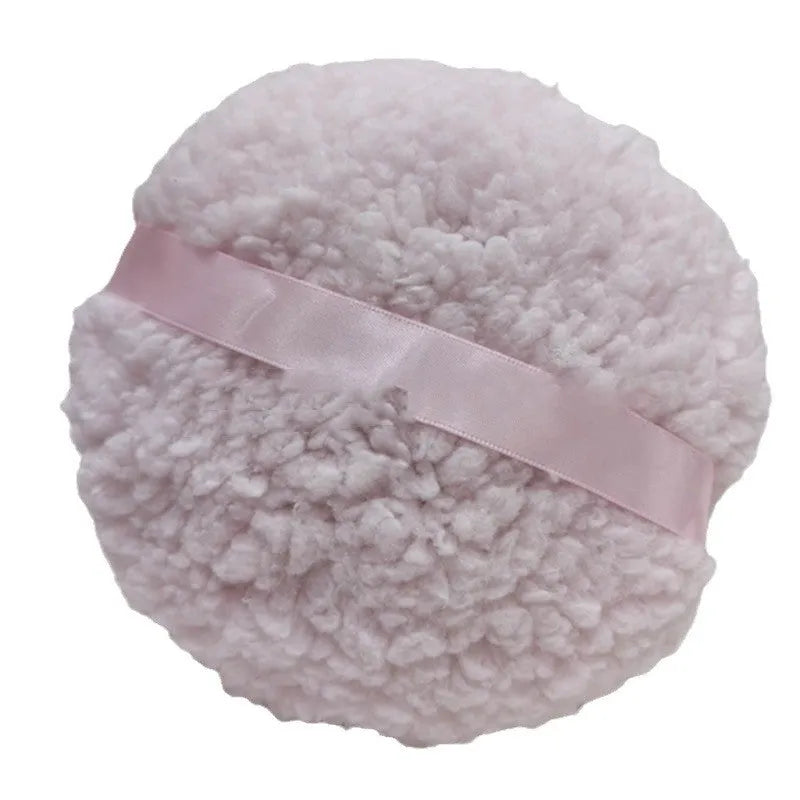 Oversized soft plush makeup powder puff in pink, white, and skin colour on a white background