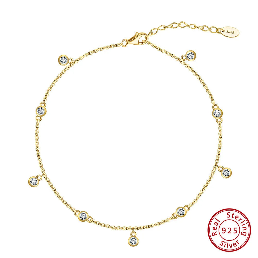 Simple silver anklet with a geometric zirconium pendant in gold colour
