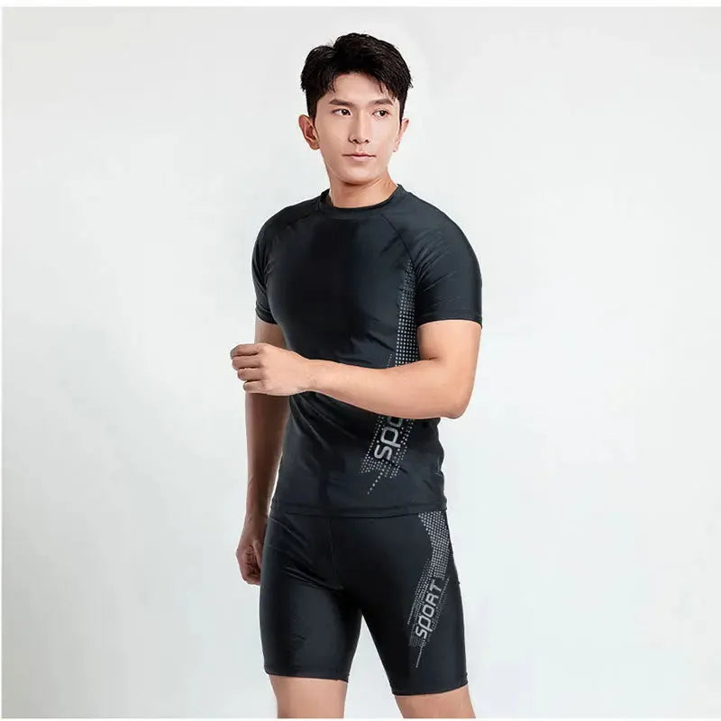 Men's two-piece polyester swim set showing short-sleeved swim top and matching trunks on a hanger.