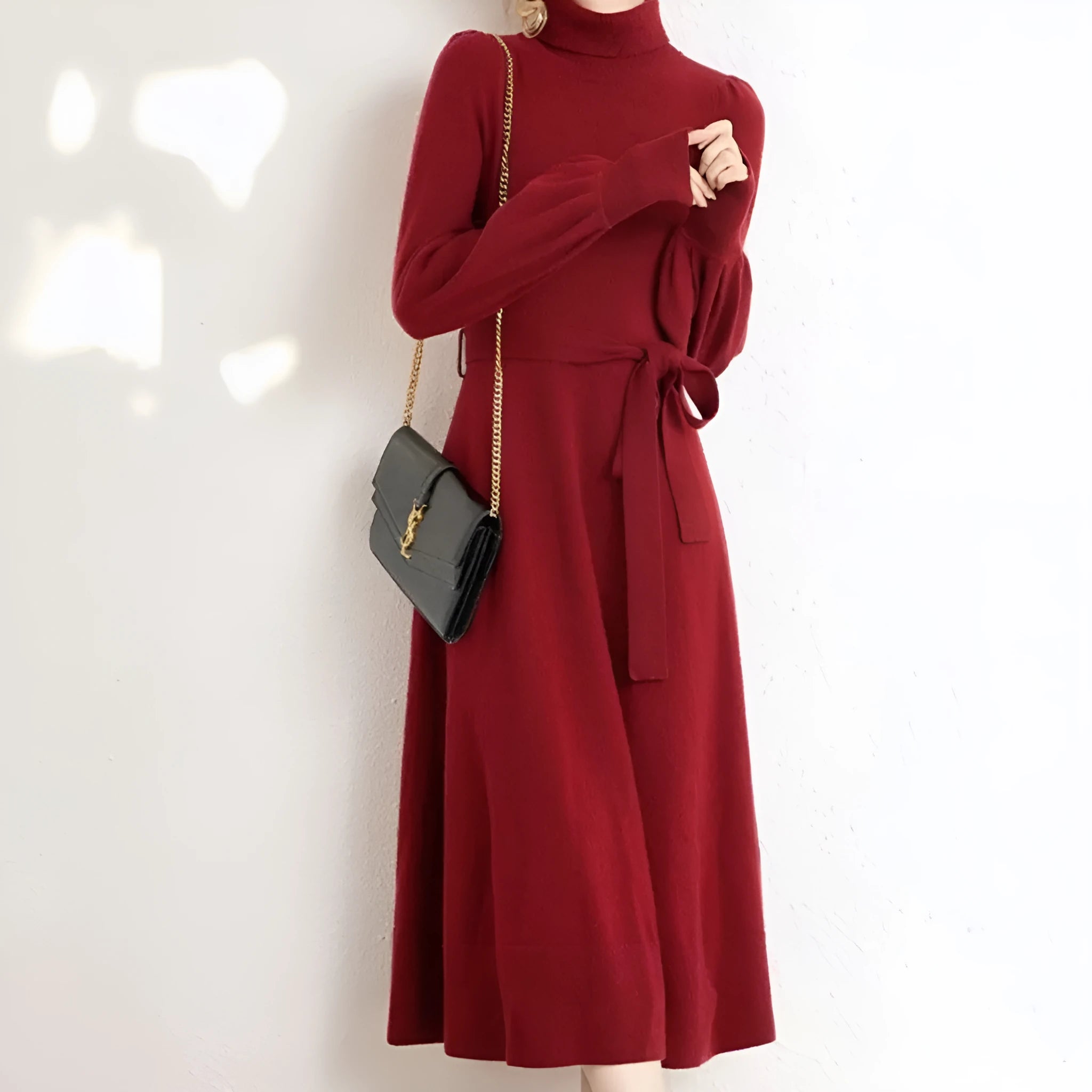 A rose red turtleneck knit dress with long sleeves, an elastic waist, and a loose mid-length skirt.