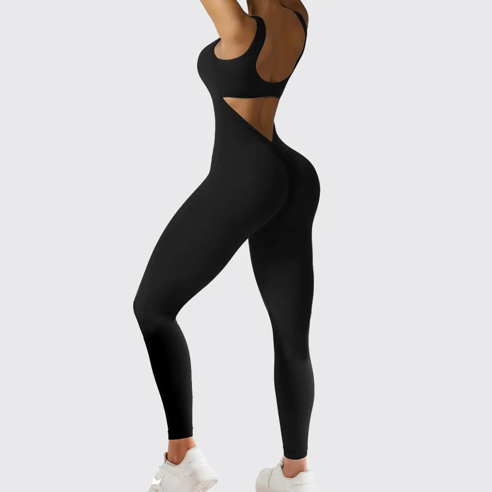 Woman wearing a sleeveless flare-leg jumpsuit for yoga in Army Green, showcasing the fashionable waist and full length.