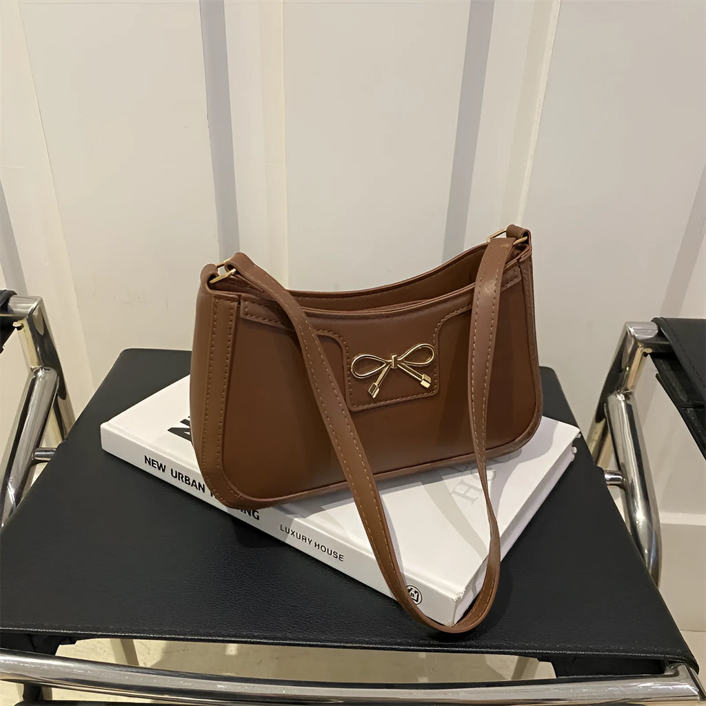 Western style baguette shoulder bag with bow detail showing horizontal square shape