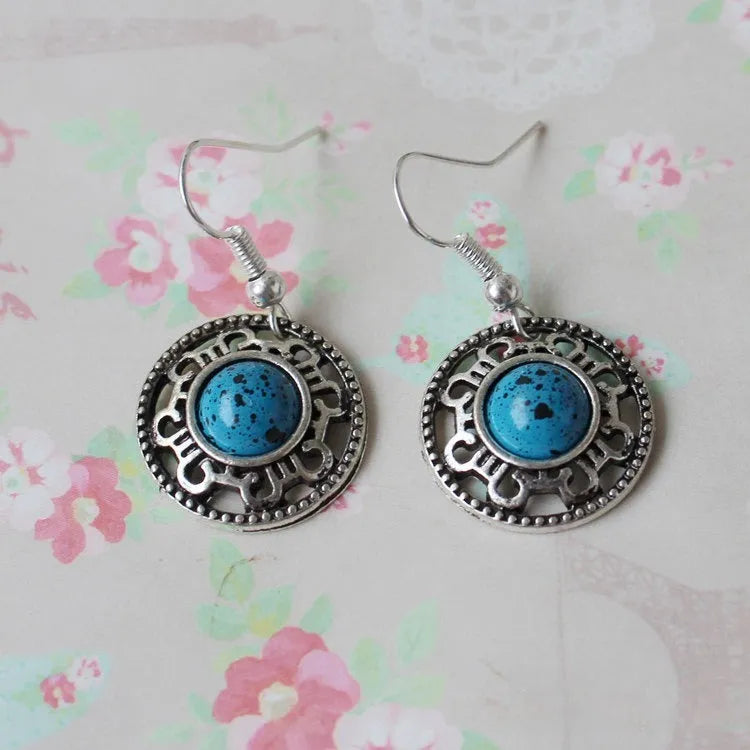 Miao silver earrings with turquoise geometric flower disk and totem patterns