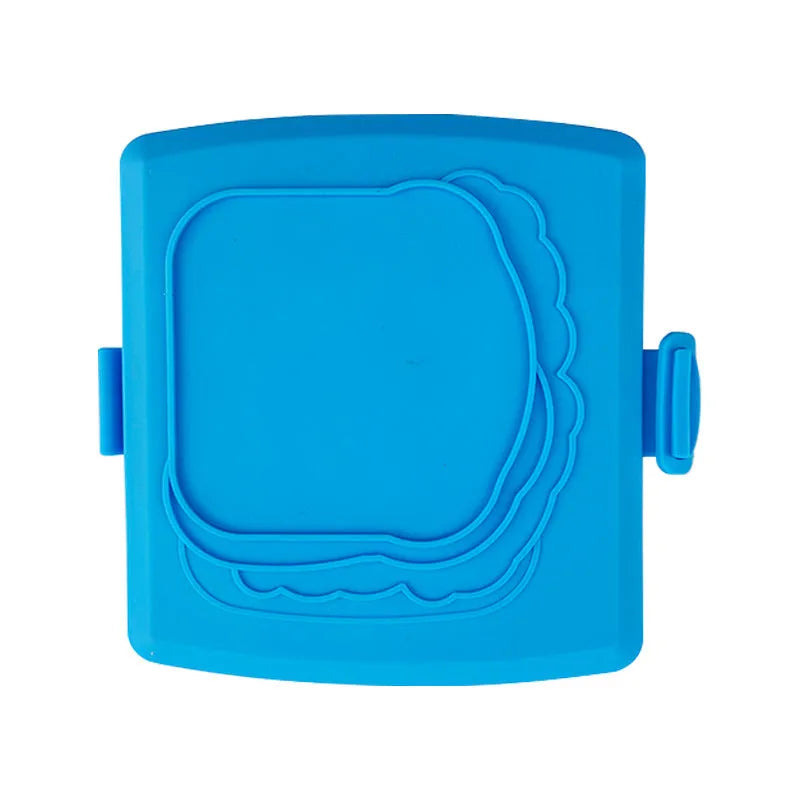 Red silicone baking tray with integrated handle and a pair of matching silicone oven gloves on a kitchen counter.