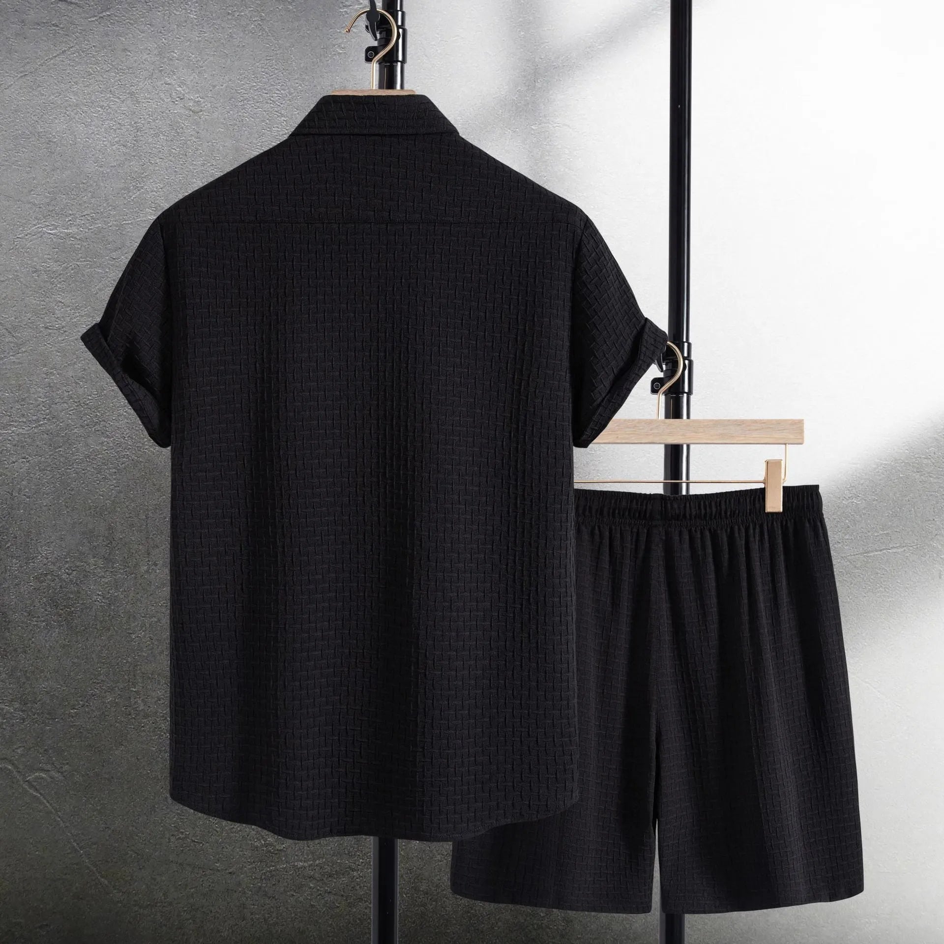 Men's black cotton blend short sleeve shirt and matching shorts set displayed together