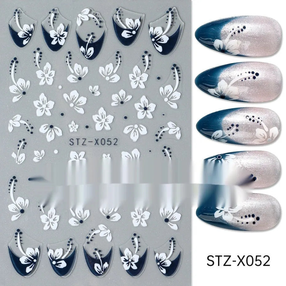 Close-up of a cartoon-style nail sticker with black and silver strips and a love pattern design on a fingernail.
