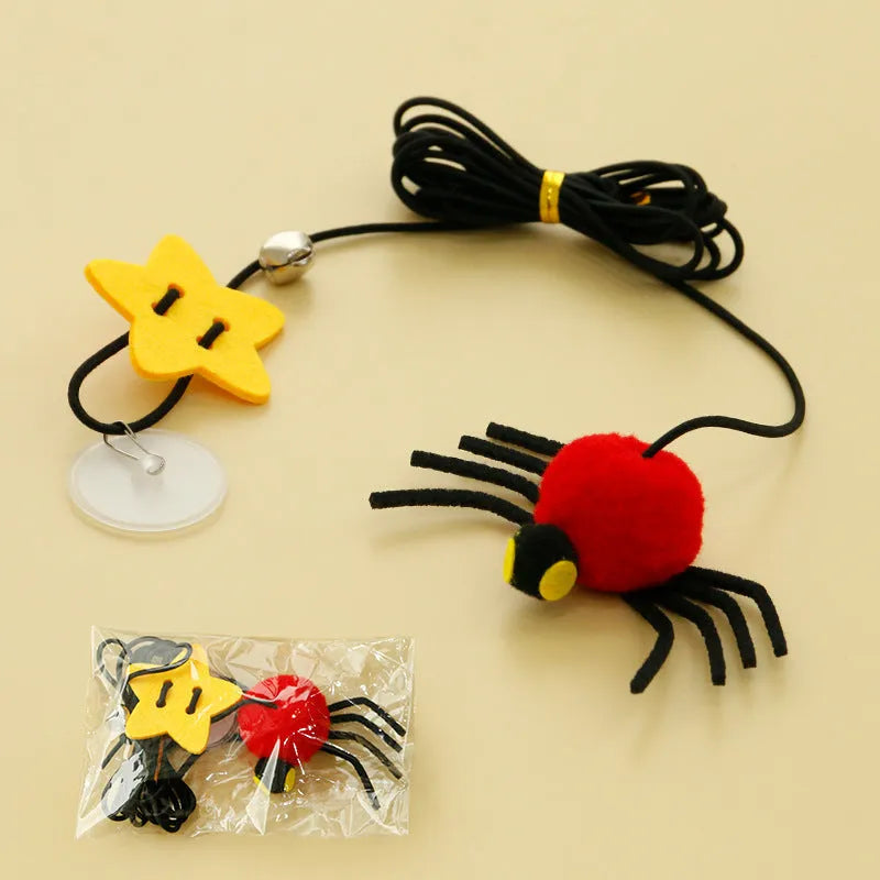 Red and yellow door-hanging cat toy with elastic rope, feather, bell and spider attachment for indoor feline play