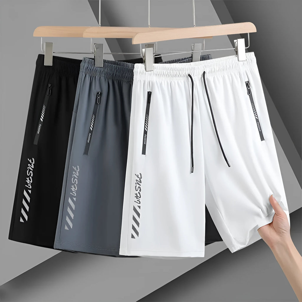 Men's black nylon quick-drying sports shorts with elastic waistband, shown in loose fit.