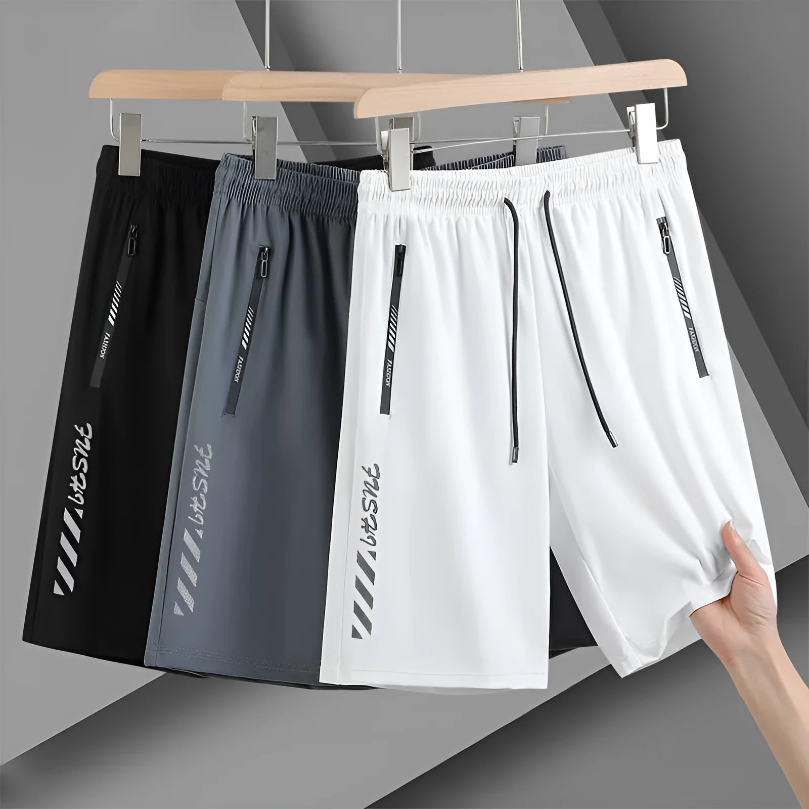 Men's black nylon quick-drying sports shorts with elastic waistband, shown in loose fit.