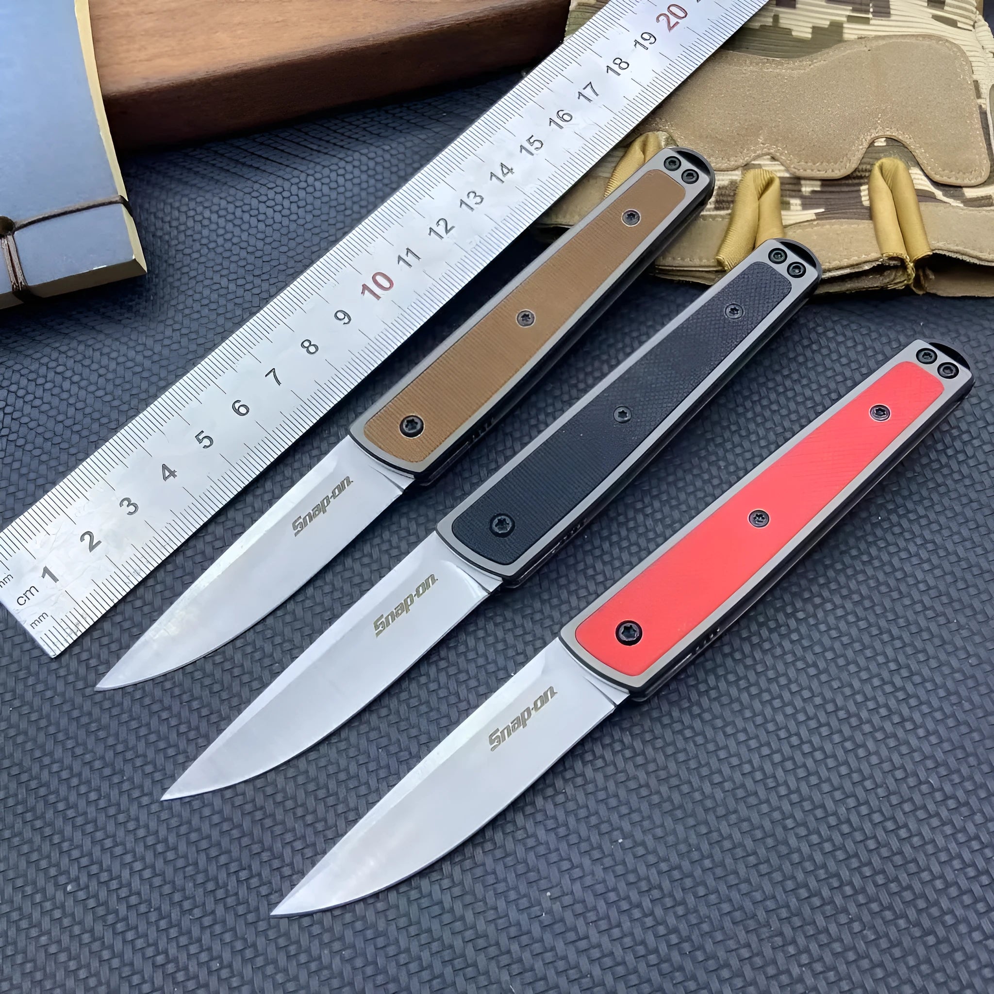 Closed and open views of a folding fruit knife with a coloured handle and stainless steel blade.
