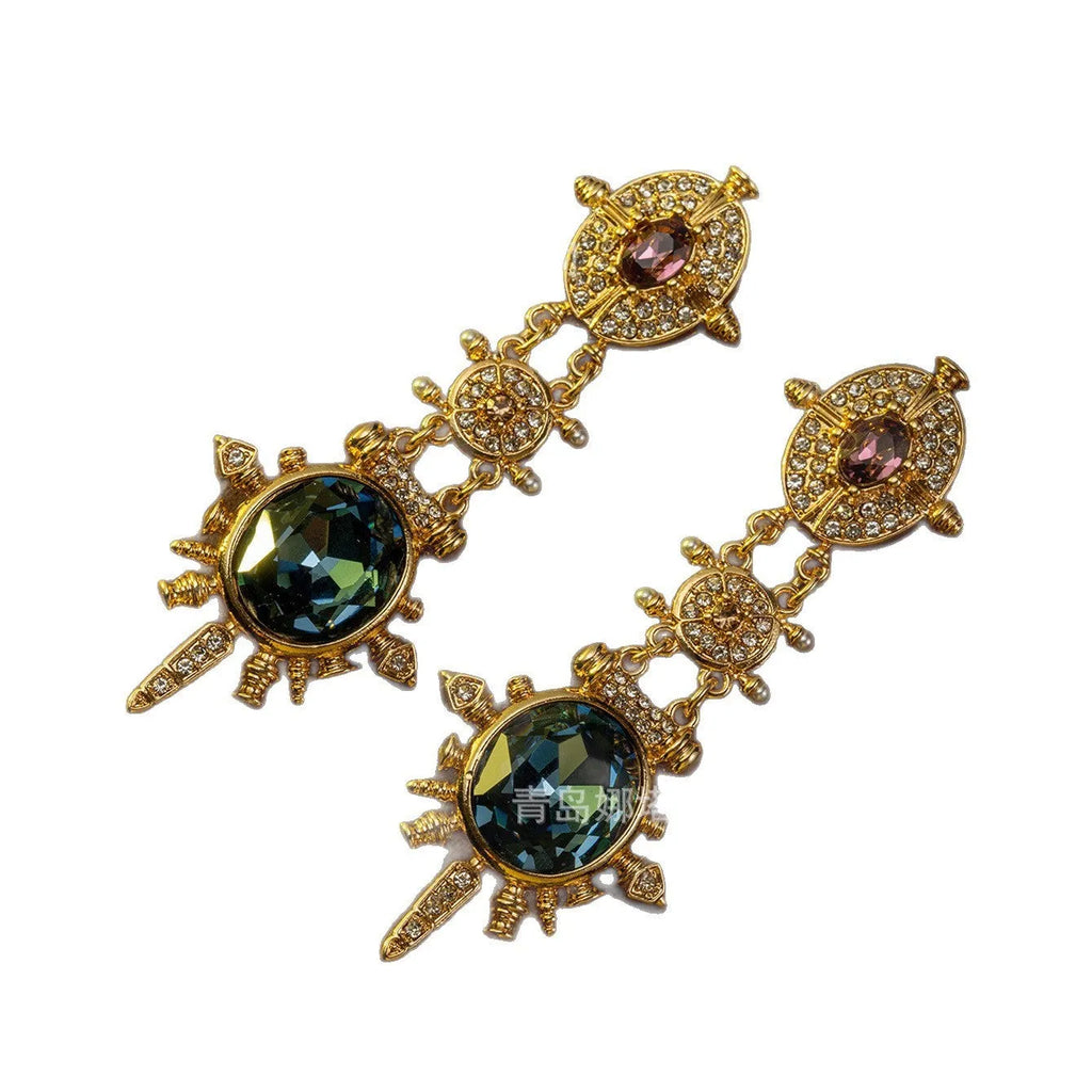 A pair of gold colour geometric round stud earrings with a retro court style design.