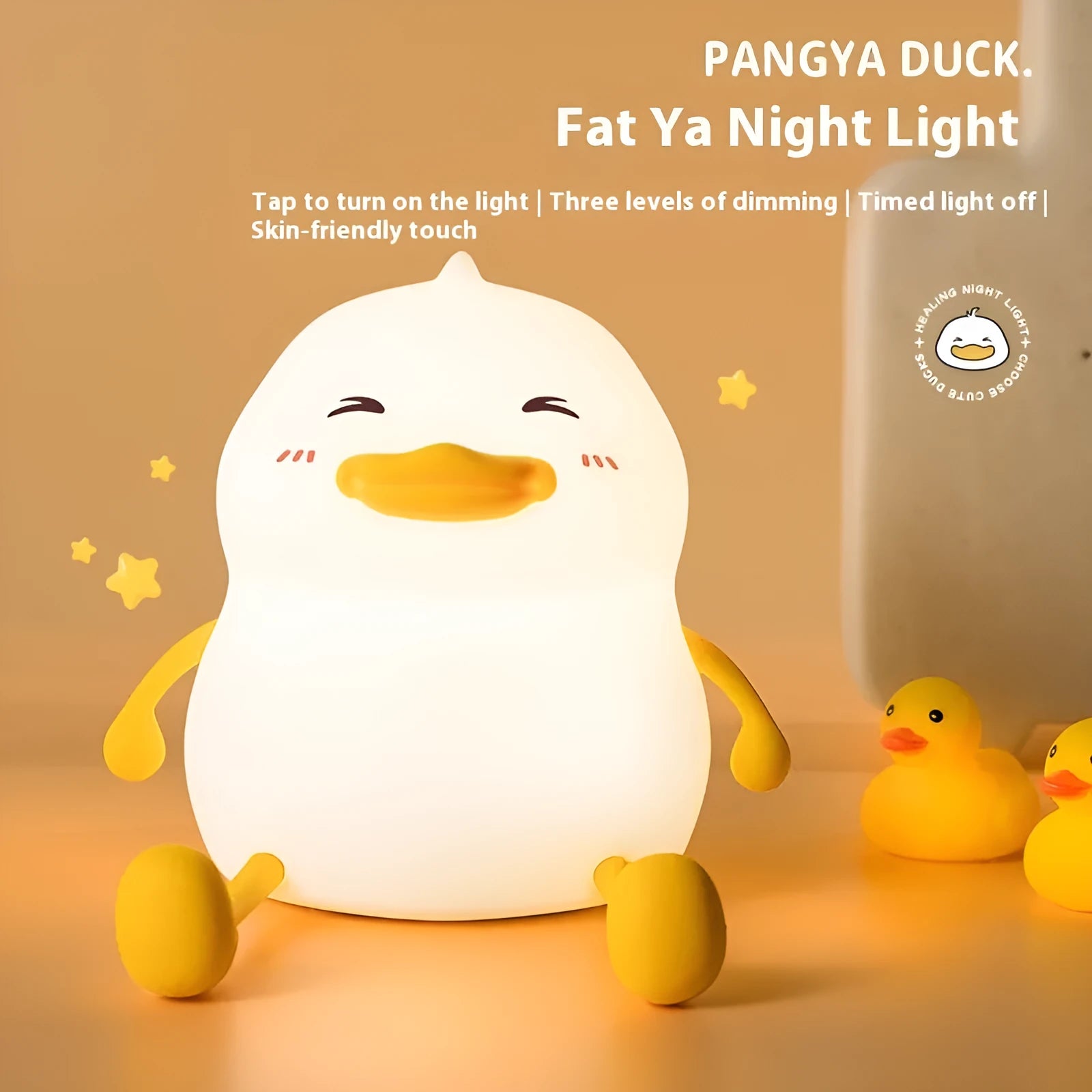 Chubby rechargeable silicone pat night lamp on desk holding a mobile phone