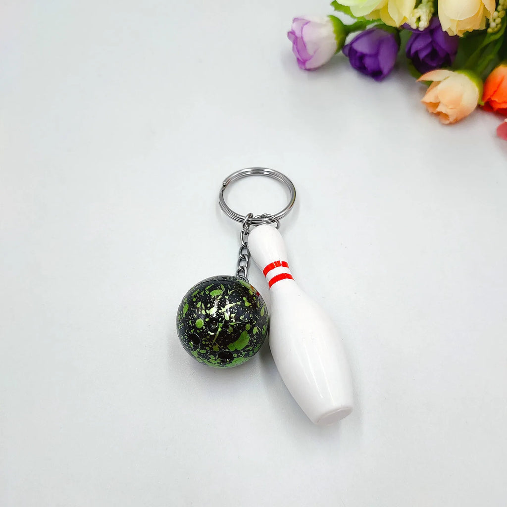 Mini bowling pin simulation keychain pendant in blue, made from PVC and metal on a key ring.