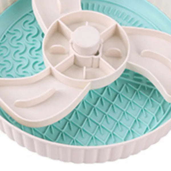 Grey plastic pet bowl with rotating windmill-pattern slow feeder licking mat inside