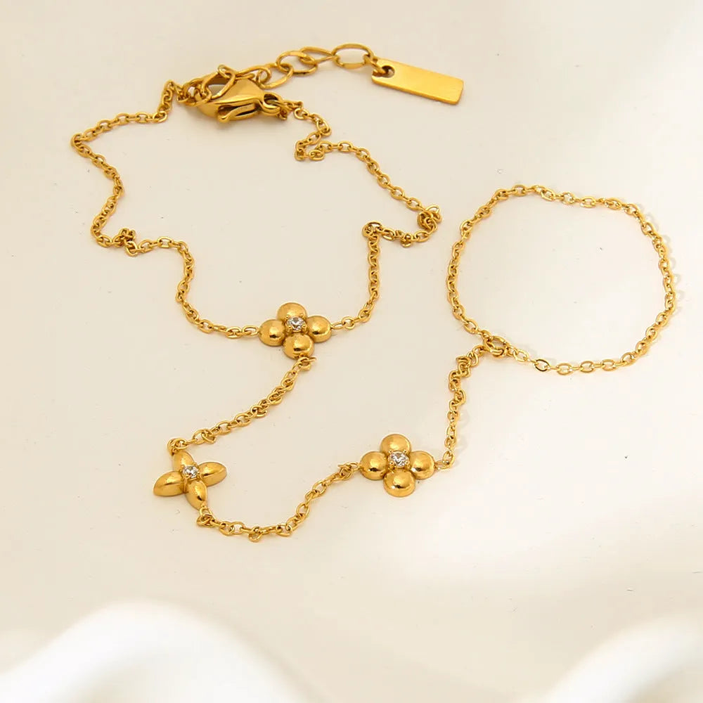 Gold-tone stainless steel women's bracelet with an eight-pointed star and floral geometric design