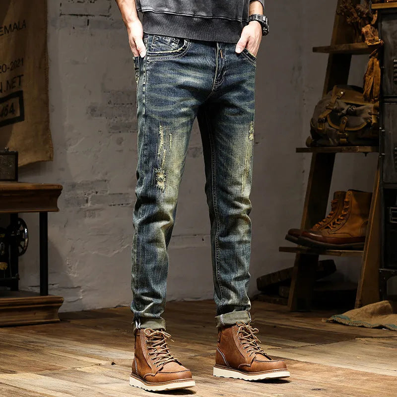 Men's skinny fit retro blue jeans with a zip fly on a grey background