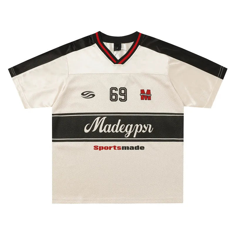 Apricot coloured loose-fit V-neck sports jersey top with short sleeves and a letters pattern.
